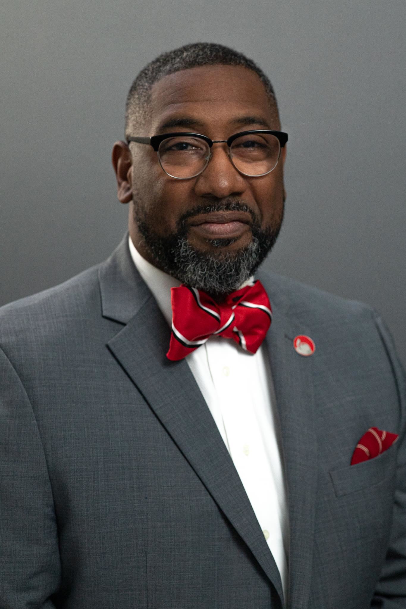 michael cole posing in a red bow tie